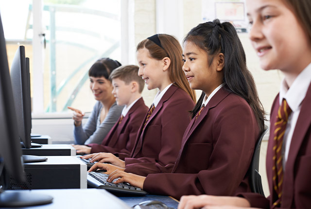 private school scholars using desktop computers